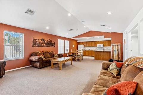 the living room of a house with couches and a table